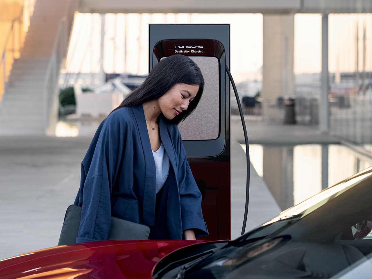 Woman charging Porsche